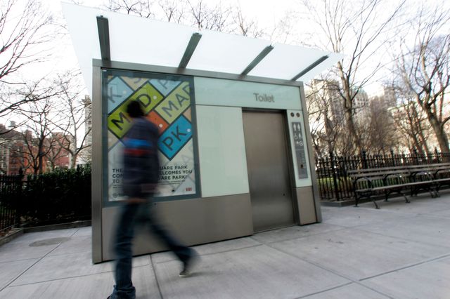 A pedestrian walks past a public, self-cleaning toilet in Madison Square Park.
